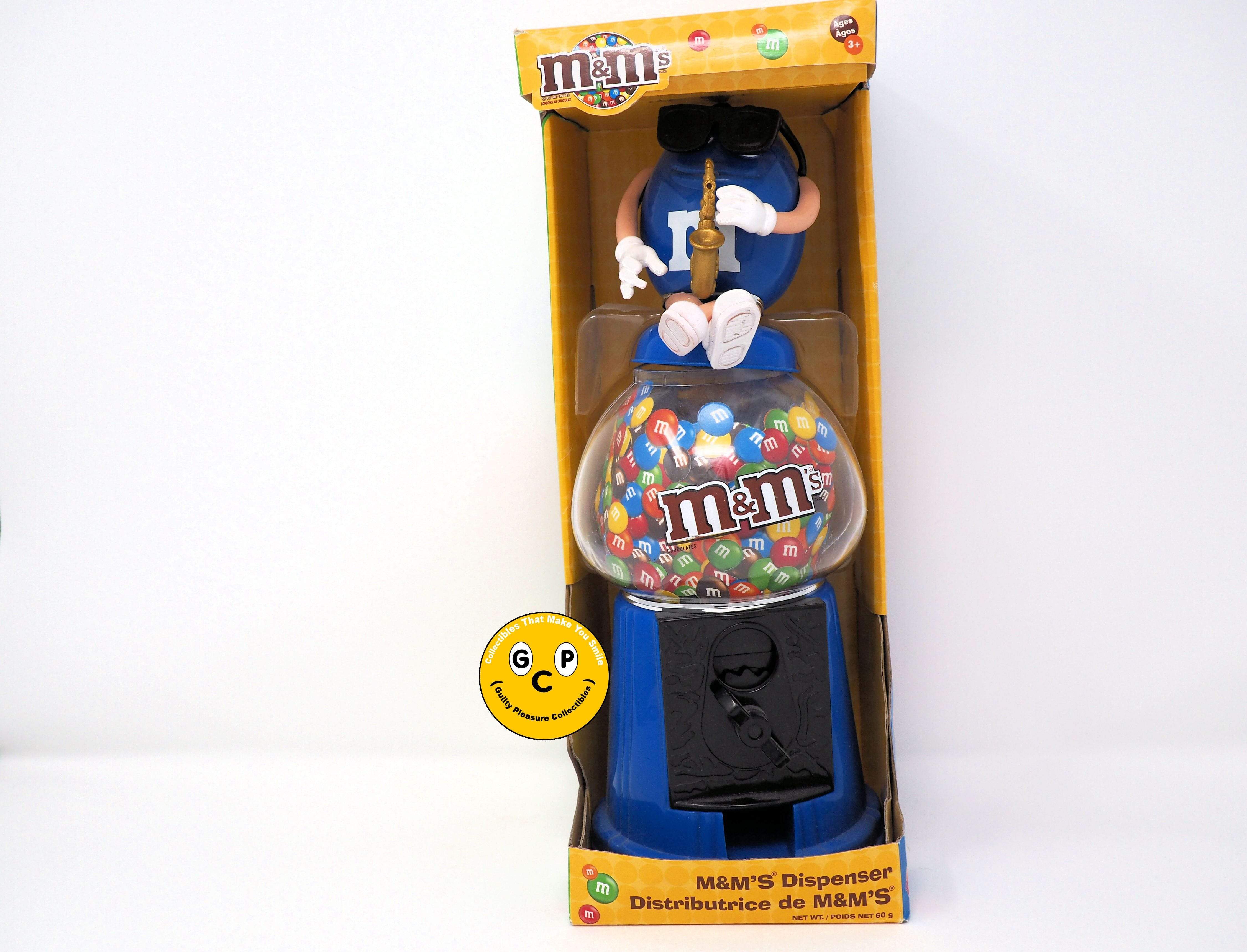http://www.guiltypleasurecollectibles.com/cdn/shop/products/m-m-s-blue-with-saxophone-candy-gumball-bank-dispenser-18590350868640.jpg?v=1618523159